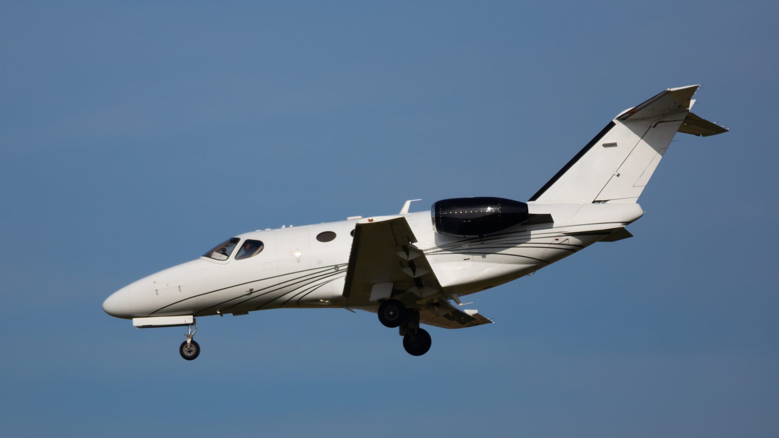 Light private jet comes in for a landing. High quality photo